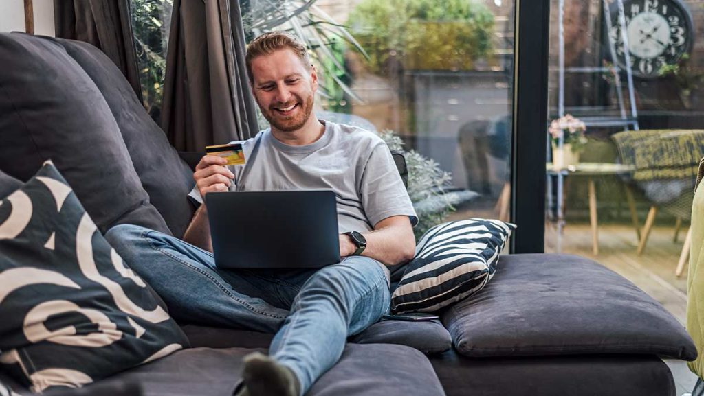 happy man looking at computer
